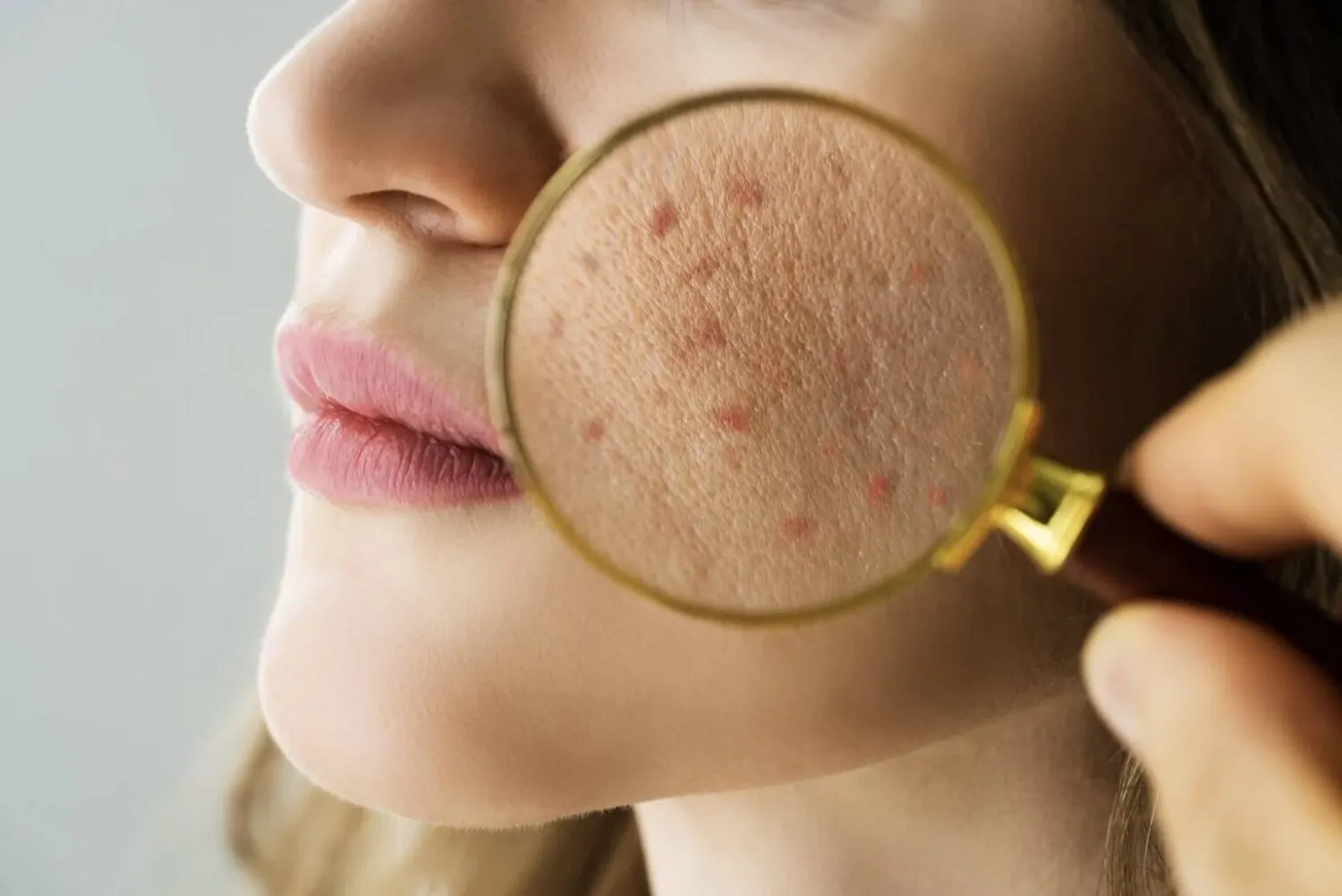 Magnifying glass held to a cheek