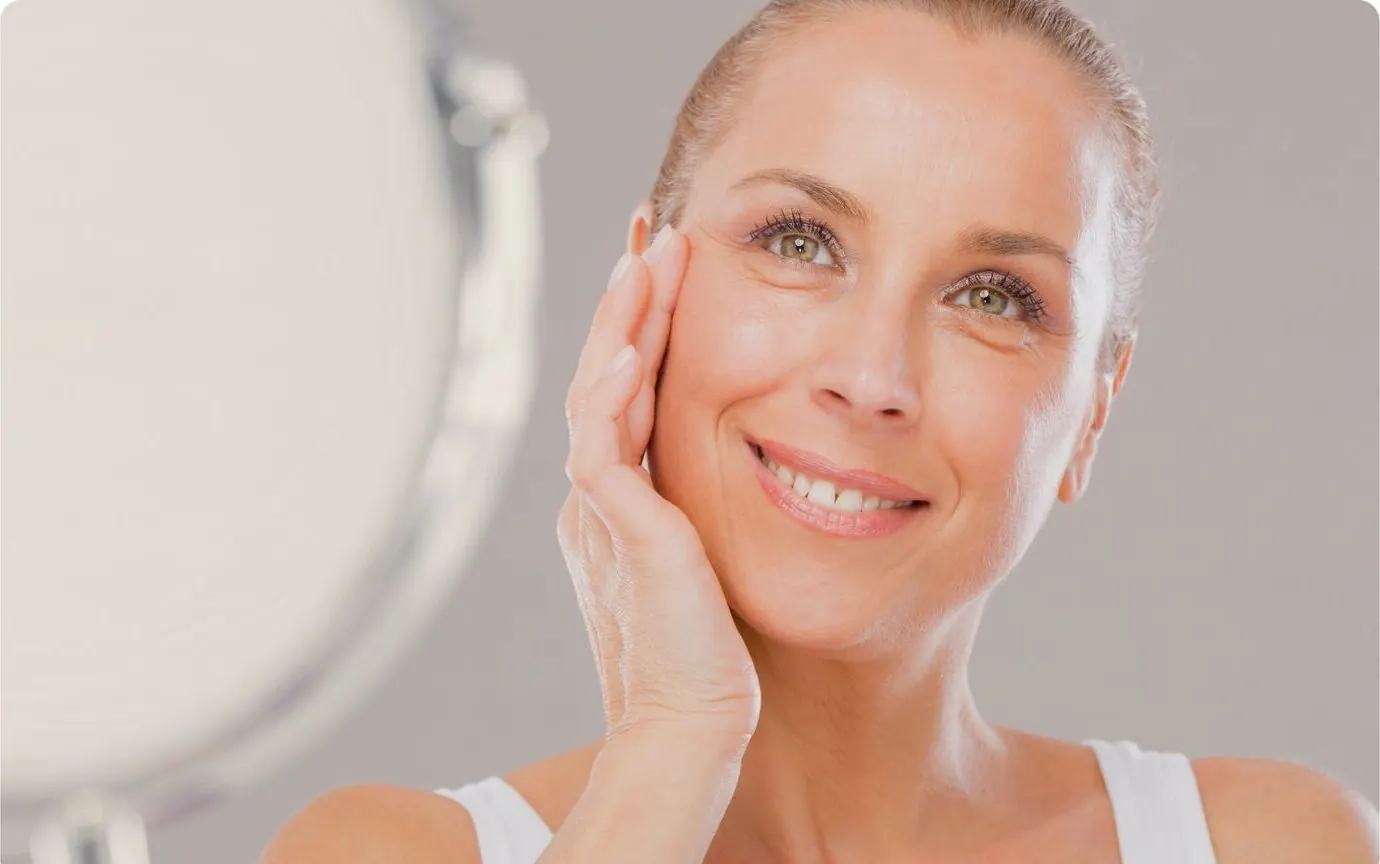 Woman smiling, hand to her cheek
